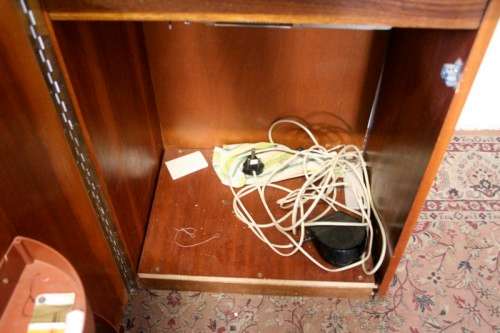 A vintage Empisal deluxe electric sewing machine in its original cabinet w/ accessories, working.