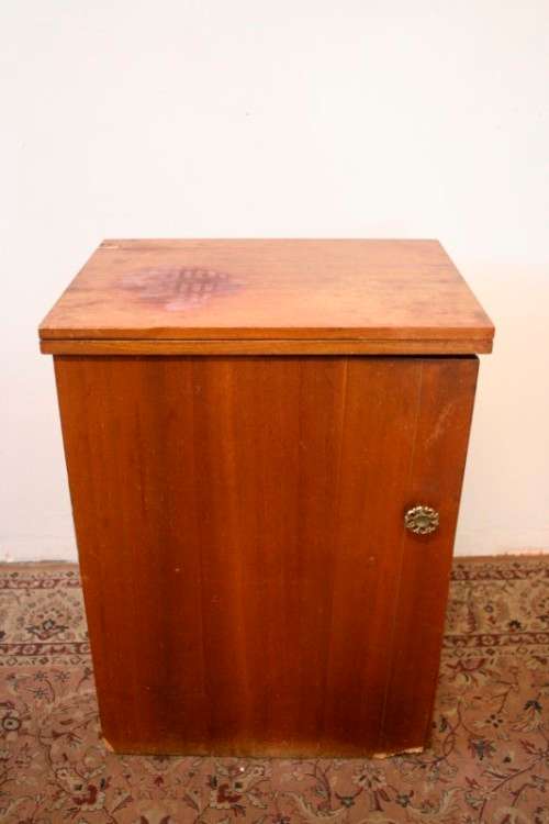 A vintage Empisal deluxe electric sewing machine in its original cabinet w/ accessories, working.