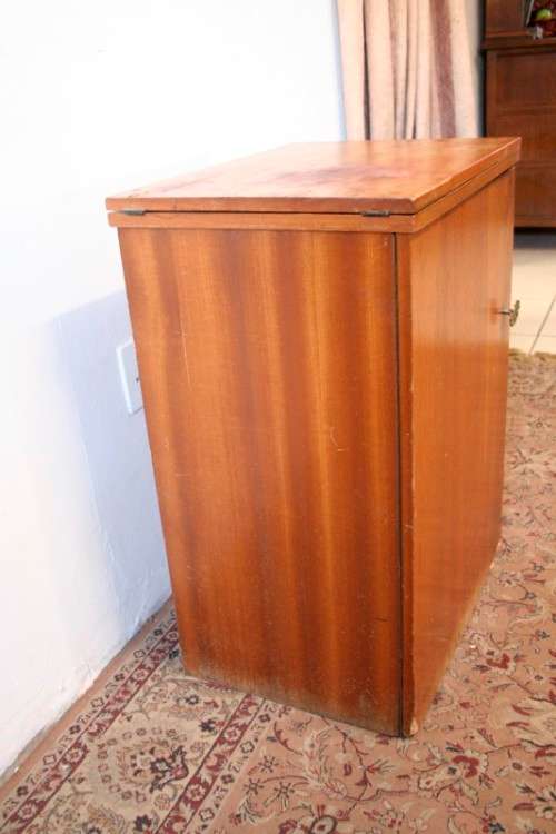 A vintage Empisal deluxe electric sewing machine in its original cabinet w/ accessories, working.