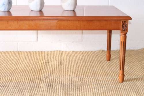 A stunning and stylish Yew wood centre coffee table with carved detailing on tapered legs