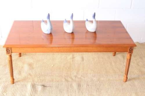 A stunning and stylish Yew wood centre coffee table with carved detailing on tapered legs
