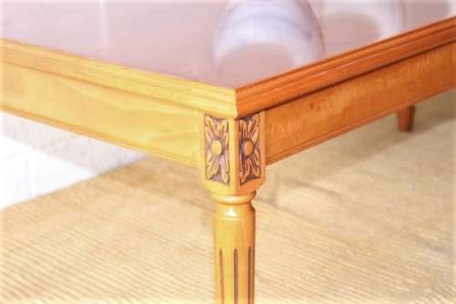 A stunning and stylish Yew wood centre coffee table with carved detailing on tapered legs