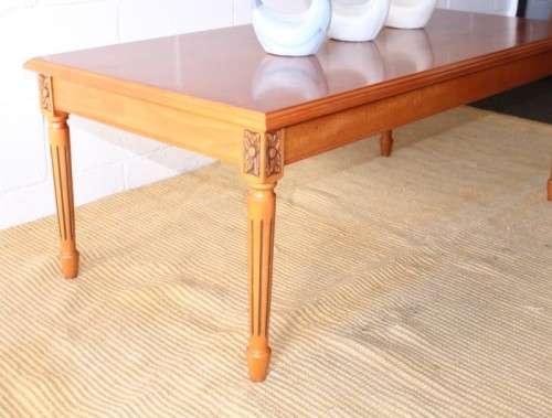 A stunning and stylish Yew wood centre coffee table with carved detailing on tapered legs