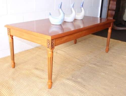 A stunning and stylish Yew wood centre coffee table with carved detailing on tapered legs