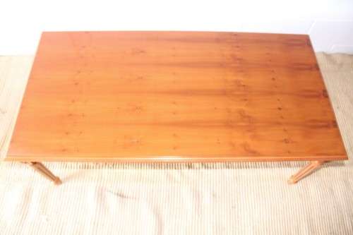 A stunning and stylish Yew wood centre coffee table with carved detailing on tapered legs