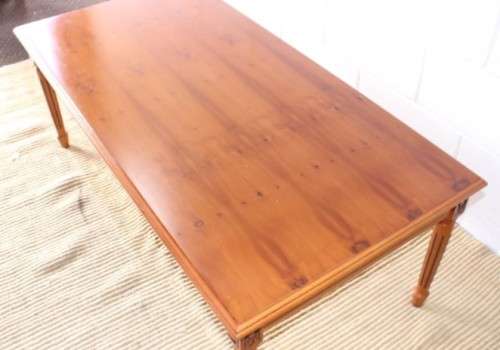 A stunning and stylish Yew wood centre coffee table with carved detailing on tapered legs