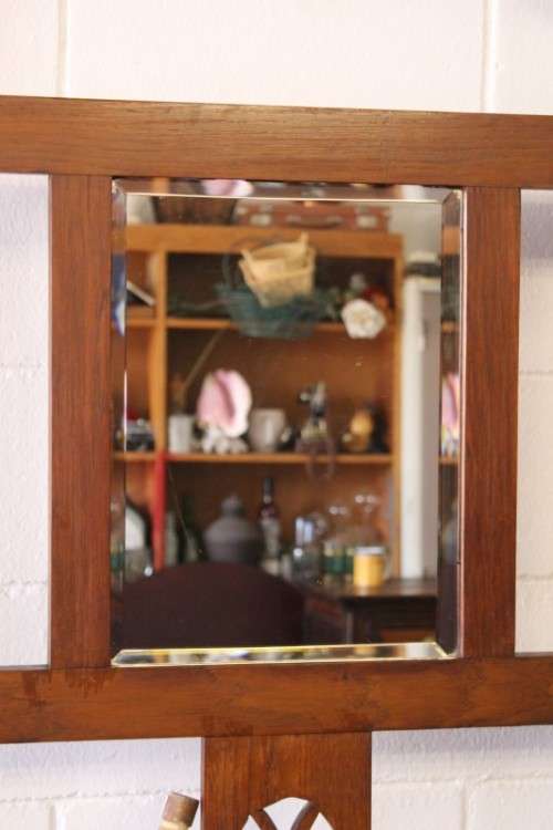 An incredible solid Oak hall stand with a bevelled mirror, "drawer" & six hooks for hats and coats!