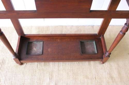 An incredible solid Oak hall stand with a bevelled mirror, "drawer" & six hooks for hats and coats!