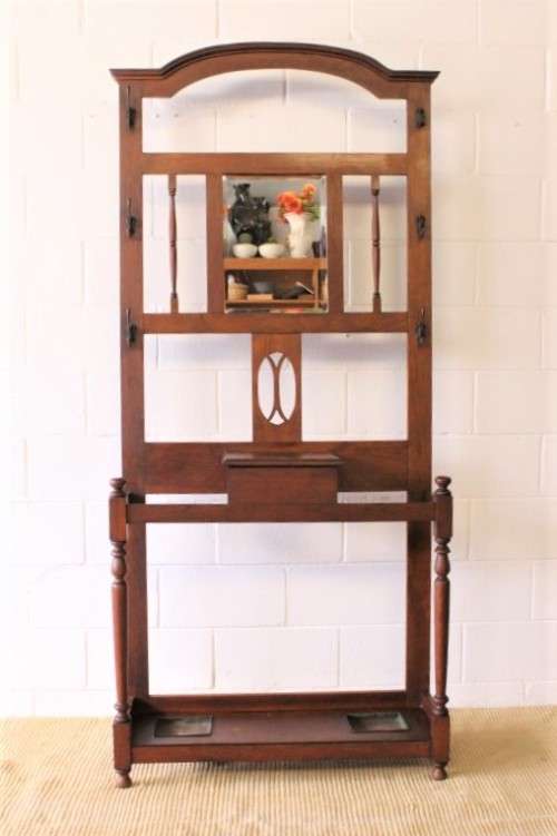 An incredible solid Oak hall stand with a bevelled mirror, "drawer" & six hooks for hats and coats!