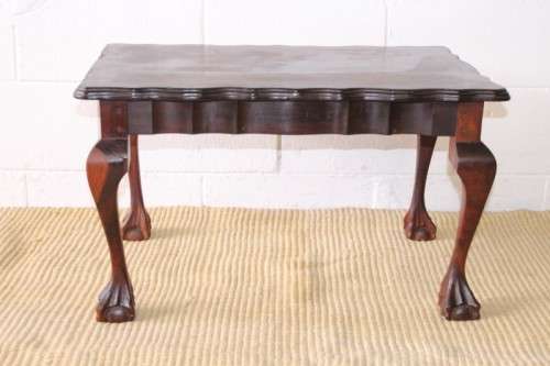 A great size vintage scalloped edge solid African Stink wood ball and claw coffee/ side table