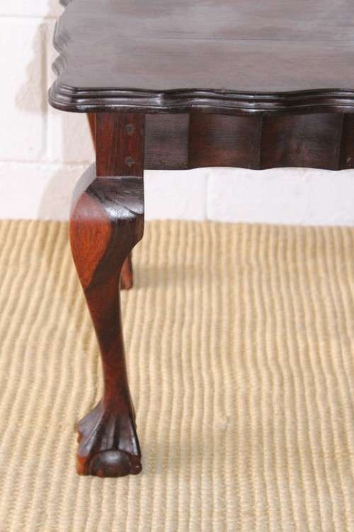 A great size vintage scalloped edge solid African Stink wood ball and claw coffee/ side table