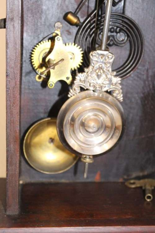 A beautiful and rare hand carved antique Ansonia "Gingerbread" shelf mantle clock with alarm bell