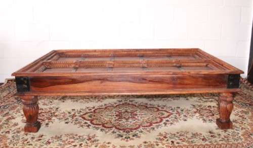 A fantastic solid Indonesian Teak carved centre coffee table w/ substantial legs and metal detailing