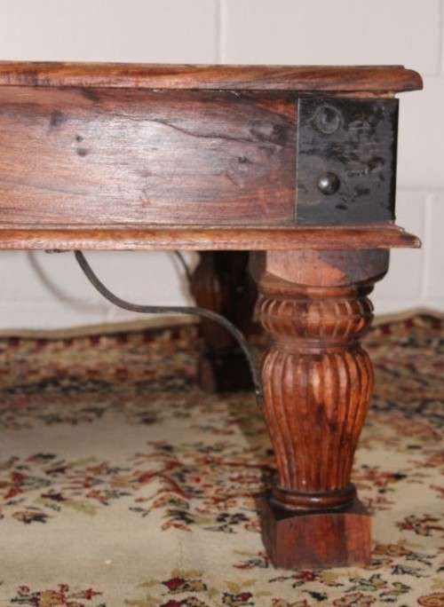A fantastic solid Indonesian Teak carved centre coffee table w/ substantial legs and metal detailing