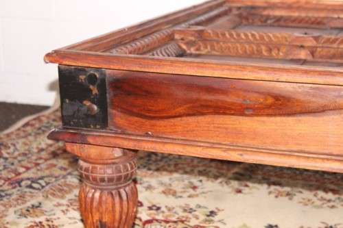 A fantastic solid Indonesian Teak carved centre coffee table w/ substantial legs and metal detailing