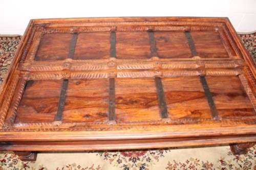 A fantastic solid Indonesian Teak carved centre coffee table w/ substantial legs and metal detailing