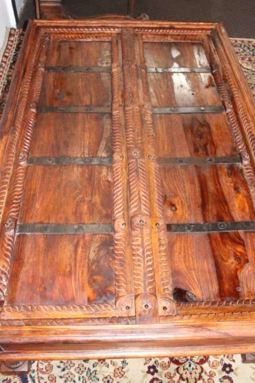 A fantastic solid Indonesian Teak carved centre coffee table w/ substantial legs and metal detailing