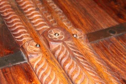 A fantastic solid Indonesian Teak carved centre coffee table w/ substantial legs and metal detailing