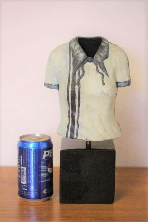 A wonderful & unusual solid cast iron sculpture of a ladies shirt set on a solid black marble base