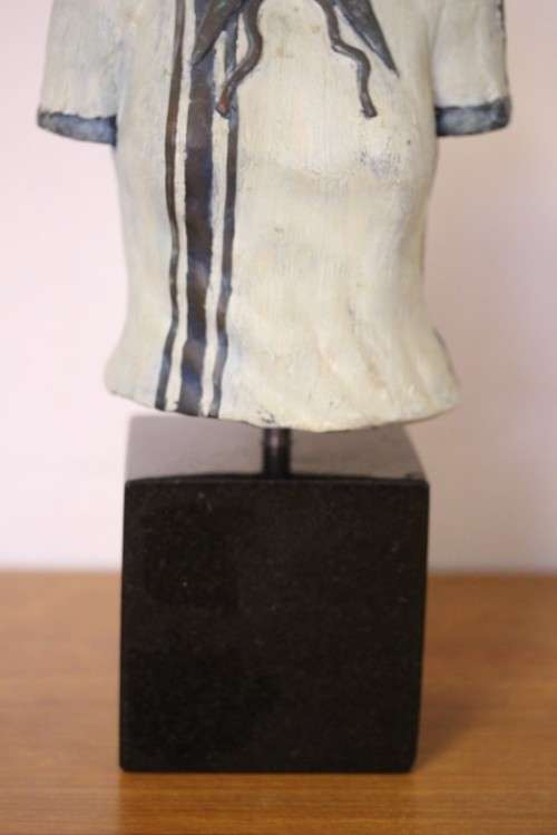 A wonderful & unusual solid cast iron sculpture of a ladies shirt set on a solid black marble base