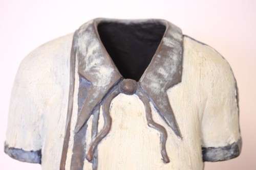 A wonderful & unusual solid cast iron sculpture of a ladies shirt set on a solid black marble base