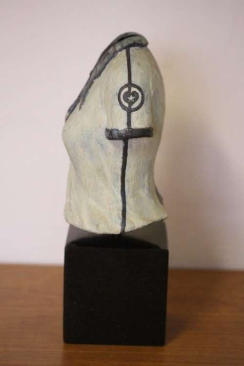 A wonderful & unusual solid cast iron sculpture of a ladies shirt set on a solid black marble base