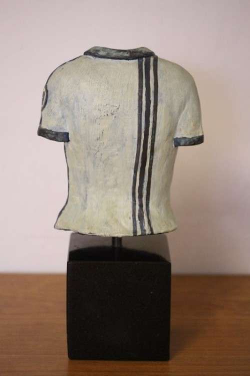 A wonderful & unusual solid cast iron sculpture of a ladies shirt set on a solid black marble base