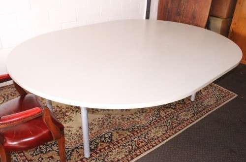 A large oval modern styled, grey painted 8 to 10-seater boardroom table on a sturdy metal frame