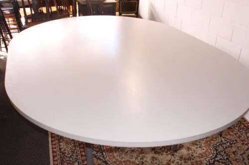A large oval modern styled, grey painted 8 to 10-seater boardroom table on a sturdy metal frame