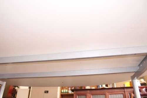 A large oval modern styled, grey painted 8 to 10-seater boardroom table on a sturdy metal frame