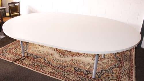 A large oval modern styled, grey painted 8 to 10-seater boardroom table on a sturdy metal frame