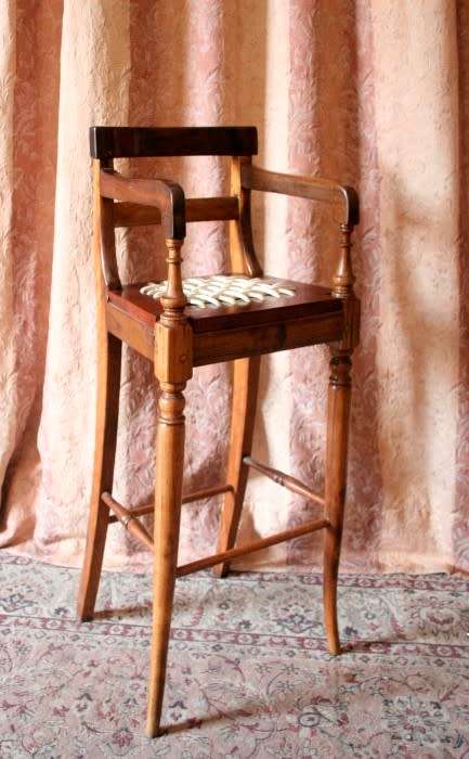 A beautifully hand made riempie baby high chair w/ white leather riempies & turned front legs