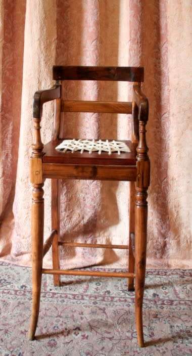 A beautifully hand made riempie baby high chair w/ white leather riempies & turned front legs