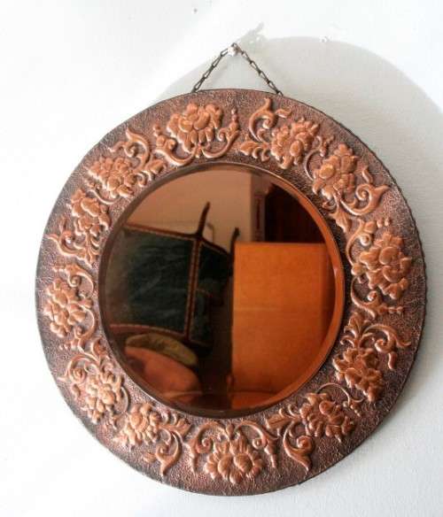 A superb antique ornately moulded copper framed round pink bevelled glass wall mirror - wow!!