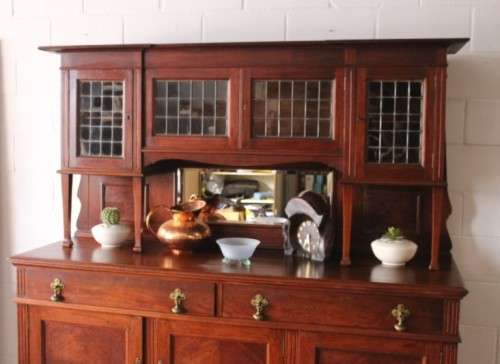 A spectacular antique Victorian honeyed-oak lead-glass door hutch buffet/ side server cabinet