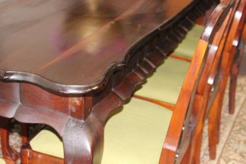 A solid blackwood scalloped edge ball & claw 8-seater dining suite with a separate cutlery table