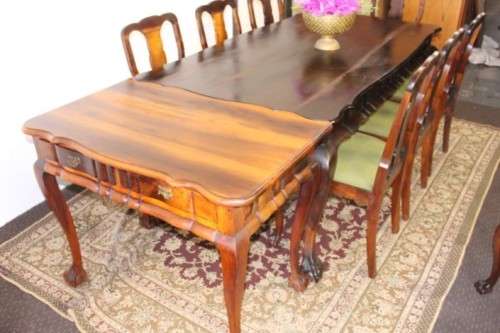 A solid blackwood scalloped edge ball & claw 8-seater dining suite with a separate cutlery table