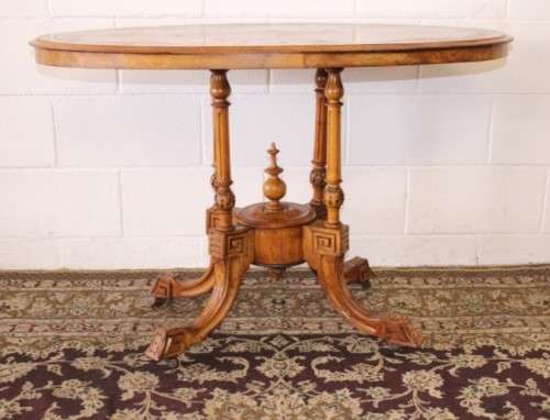 An incredible antique walnut & walnut burr carved loo table w/ marquetry inlay detailing on castors