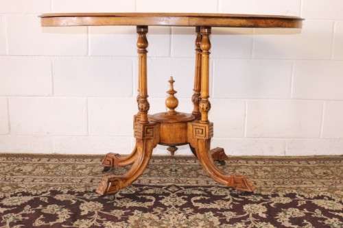An incredible antique walnut & walnut burr carved loo table w/ marquetry inlay detailing on castors