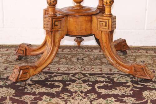 An incredible antique walnut & walnut burr carved loo table w/ marquetry inlay detailing on castors