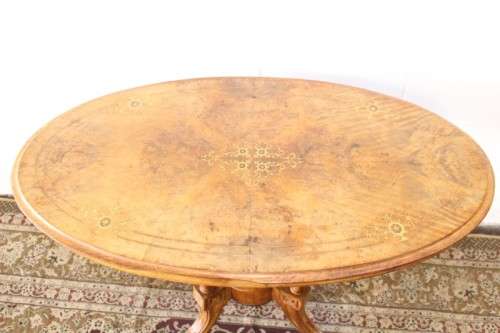 An incredible antique walnut & walnut burr carved loo table w/ marquetry inlay detailing on castors