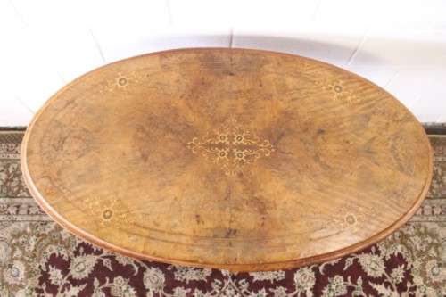 An incredible antique walnut & walnut burr carved loo table w/ marquetry inlay detailing on castors