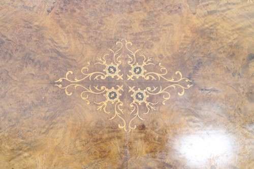 An incredible antique walnut & walnut burr carved loo table w/ marquetry inlay detailing on castors