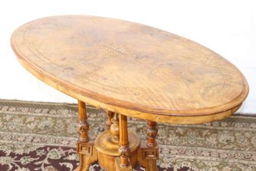 An incredible antique walnut & walnut burr carved loo table w/ marquetry inlay detailing on castors
