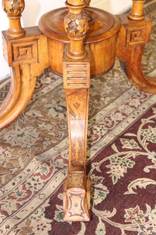 An incredible antique walnut & walnut burr carved loo table w/ marquetry inlay detailing on castors