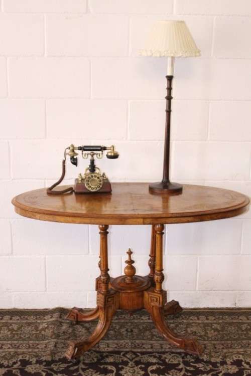 An incredible antique walnut & walnut burr carved loo table w/ marquetry inlay detailing on castors