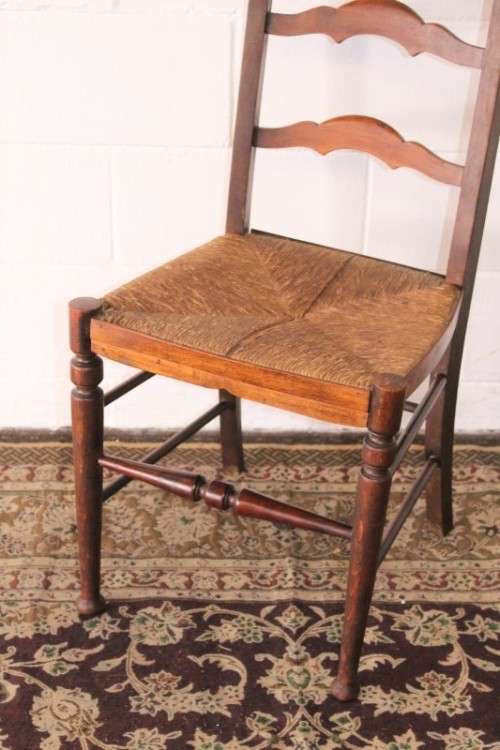 **RS17** A wonderful antique oak ladder-back dining/ occasional chair with a woven grass seat