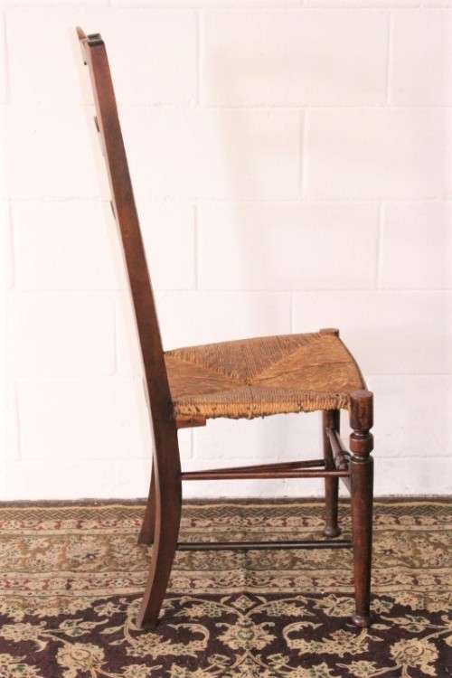 **RS17** A wonderful antique oak ladder-back dining/ occasional chair with a woven grass seat