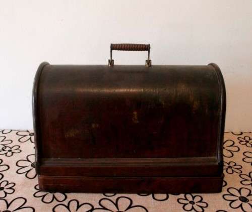 A remarkable antique (1903) Singer hand cranked sewing machine in its original casing.