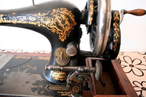 A remarkable antique (1903) Singer hand cranked sewing machine in its original casing.